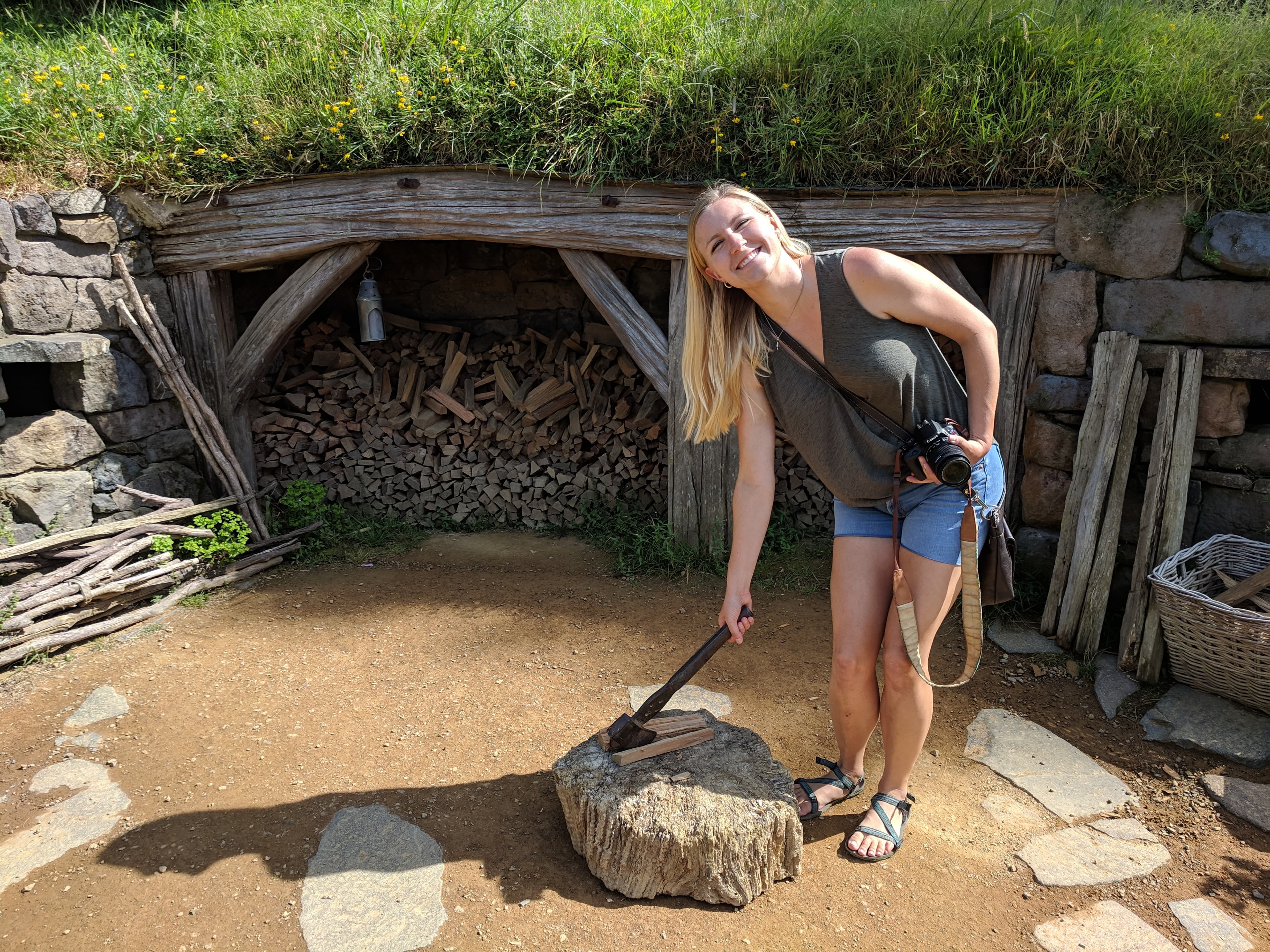 Lauren at a wood chopping spot for scale