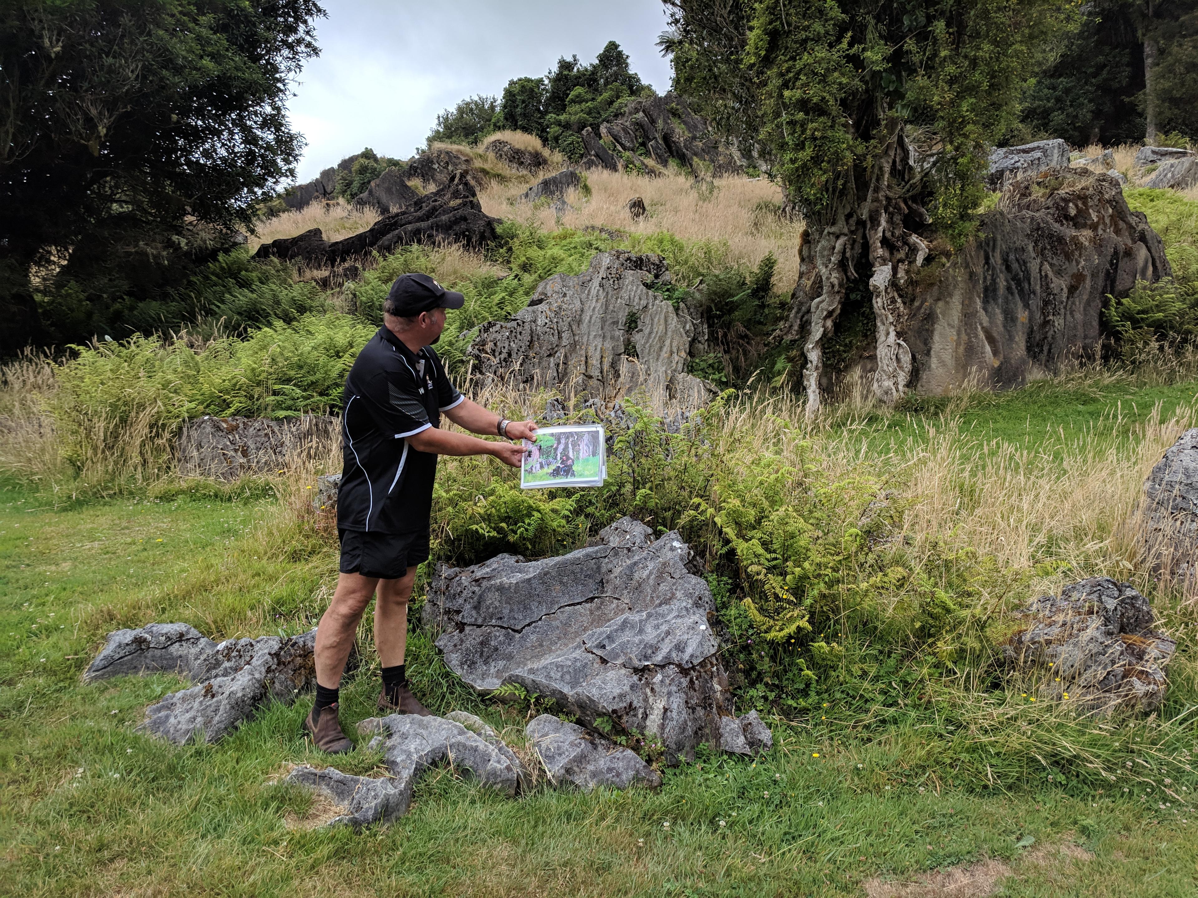 Our guide showing us pictures of The Hobbit for comparison at Hairy Feet Waitomo