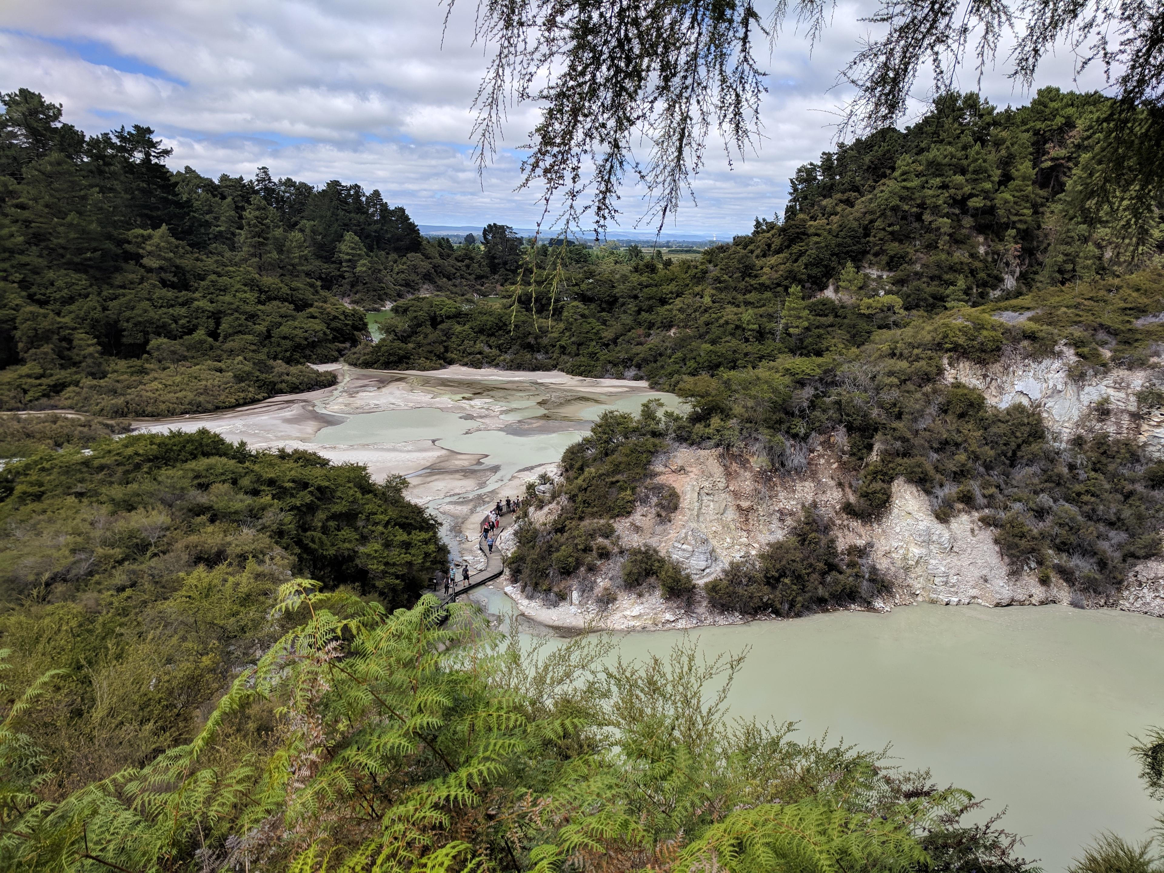 People crossing pools at Wai-O-Tapu Thermal Wonderland