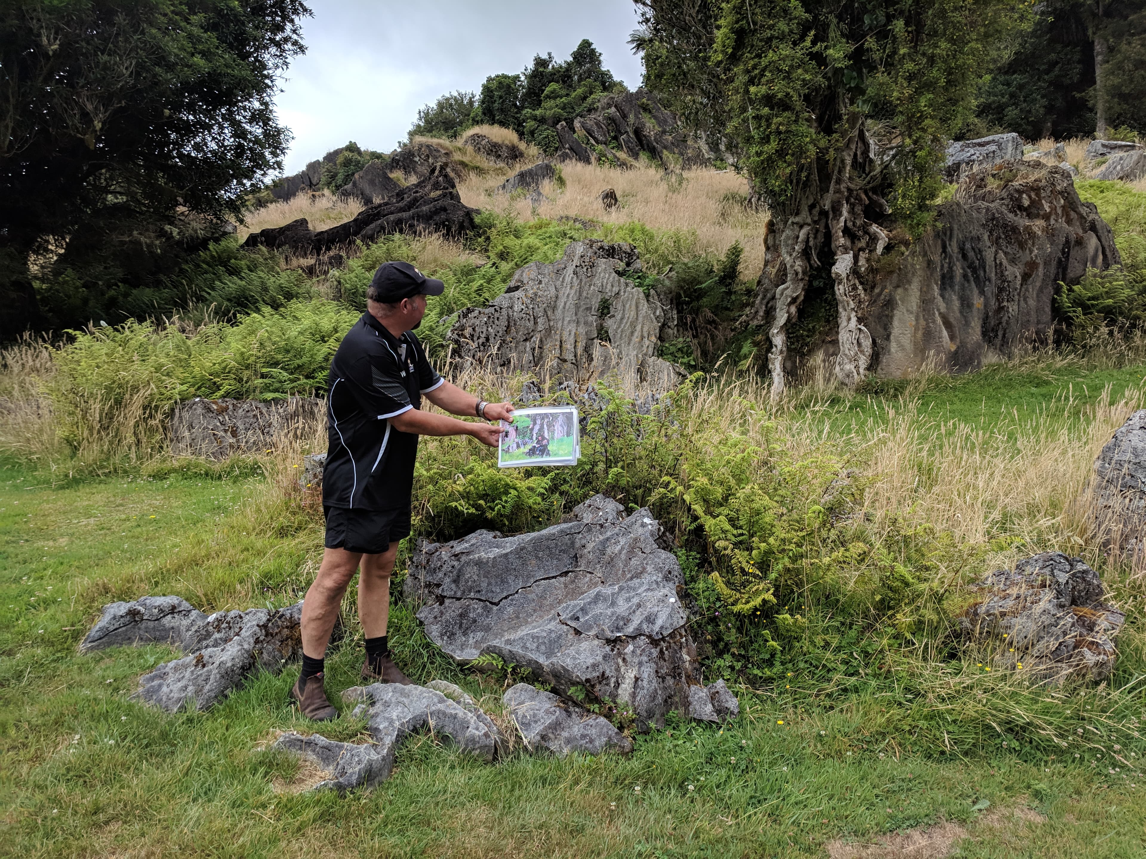 Our guide showing us pictures of The Hobbit for comparison at Hairy Feet Waitomo Our guide showing us pictures of The Hobbit for comparison at Hairy Feet Waitomo